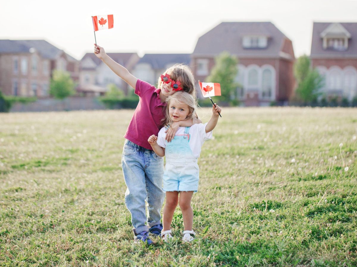 A family celebrating with a Canadian flag